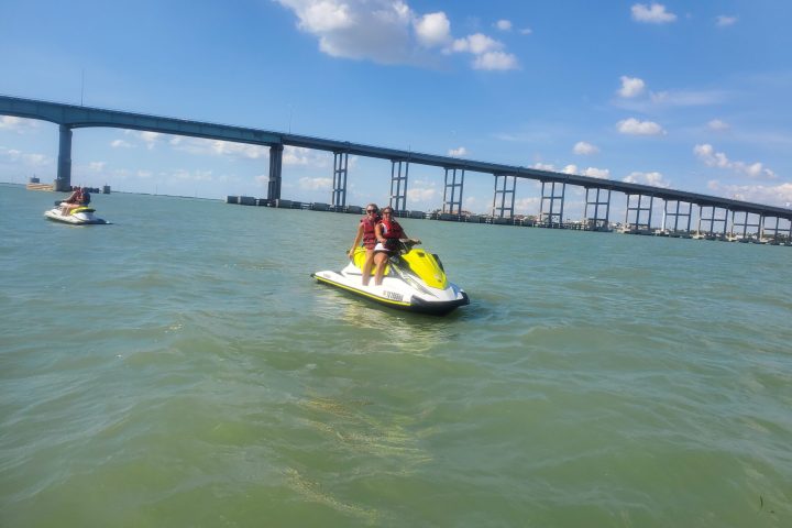 a boat traveling across a bridge over a body of water