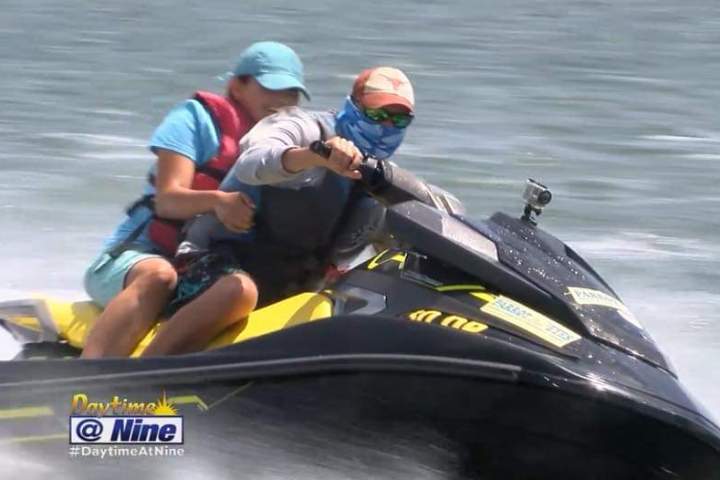 a man riding on the back of a boat