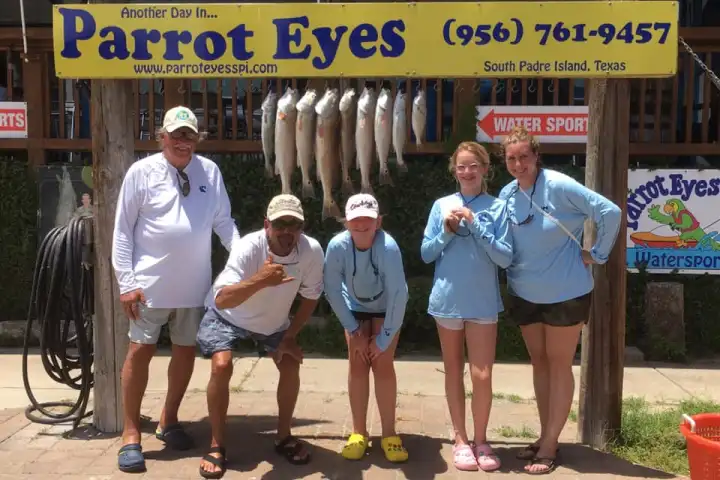 a group of people standing in front of a sign