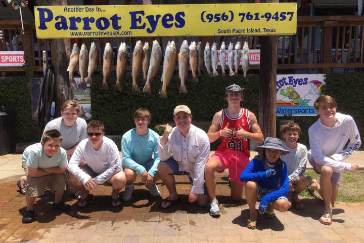 a group of people standing in front of a store